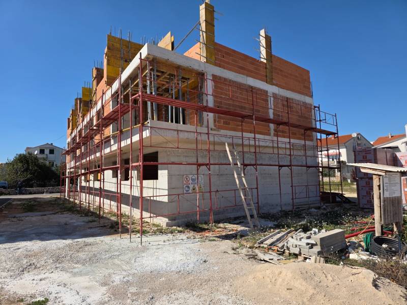 A construction project of a 3-room apartment in Srima, which is under construction with scaffolding.