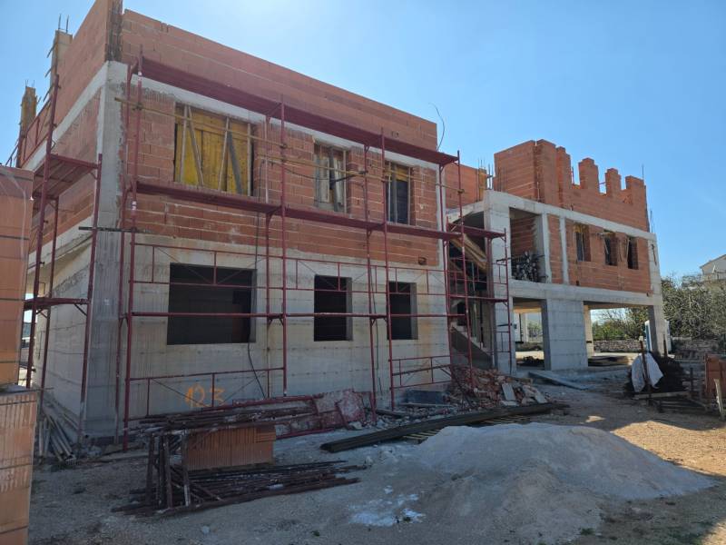 An unfinished 3-room apartment in the town of Srima with scaffolding and construction materials.