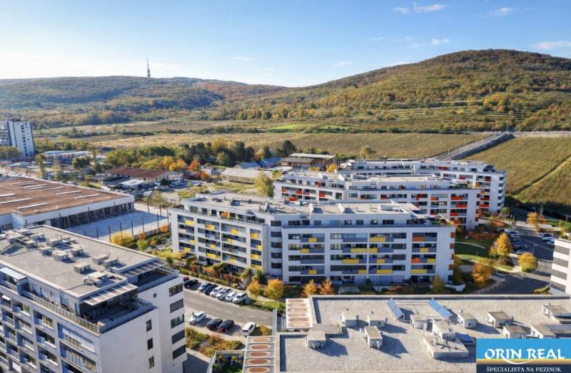 A view of residential buildings on Malokrasňanská Street in Bratislava - Rača surrounded by greenery.