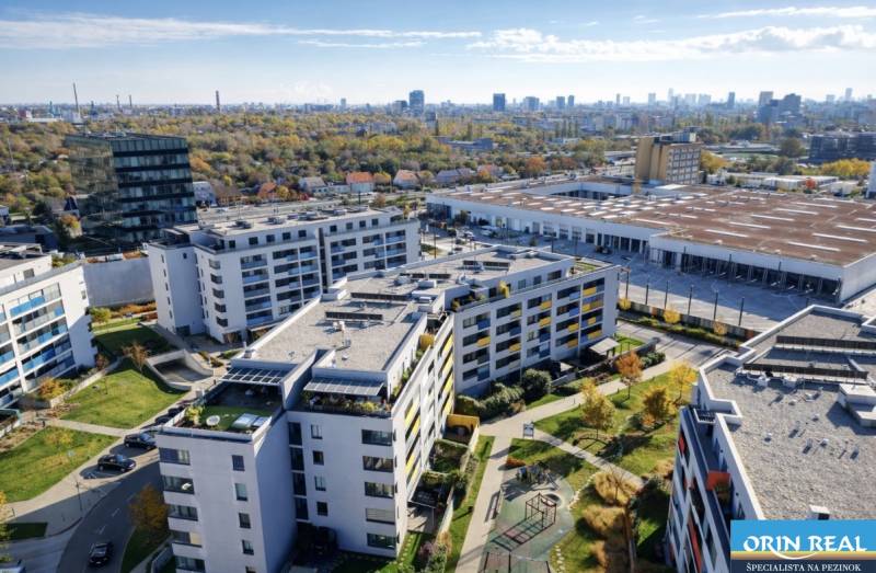Aerial view of residential buildings with a playground on Malokrasňanská Street in Bratislava-Rača.