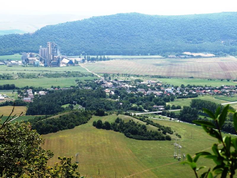 A view of agricultural and forest land in Dvorníky-Včeláre with an industrial area.