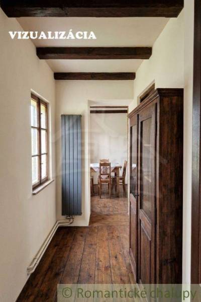Wooden beams, wood-patterned floor, and an antique cabinet in a family house.