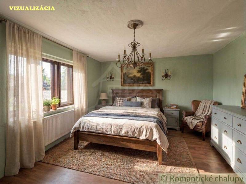 A bedroom with rustic furniture, a wooden decor floor, and a large window in a family house.