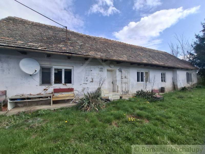 A family house in Ozdín with a white facade and a satellite dish on the roof.