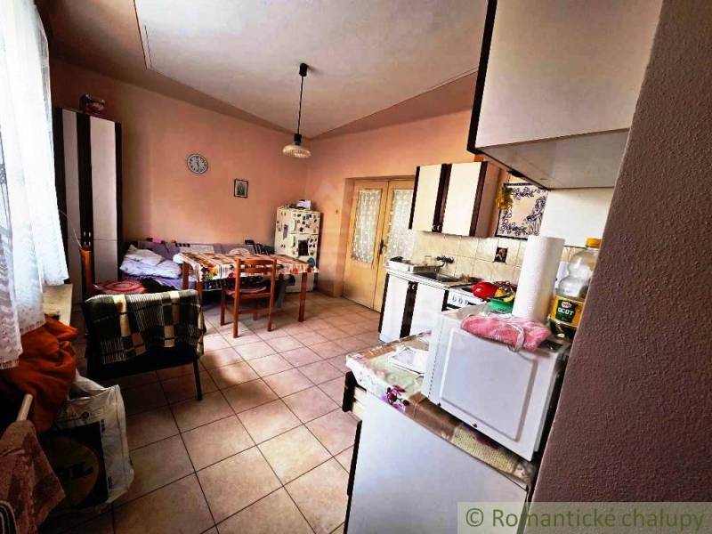Kitchen in a family house with a dining table, chair, and kitchen appliances.