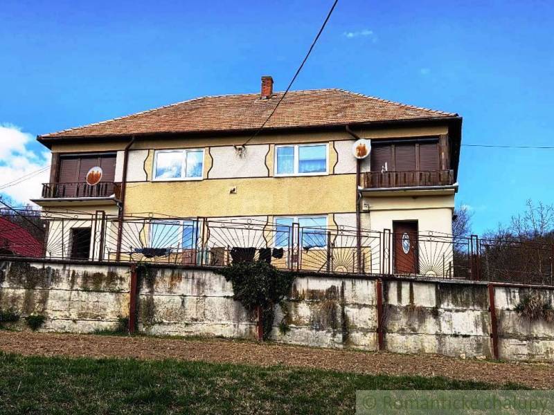 A family house in Kiarov with a brick fence and a satellite dish.