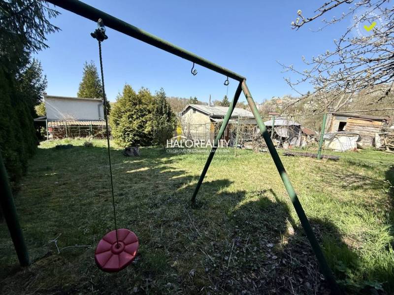 Gardens in Rimavská Sobota with a children's swing and grassy area.