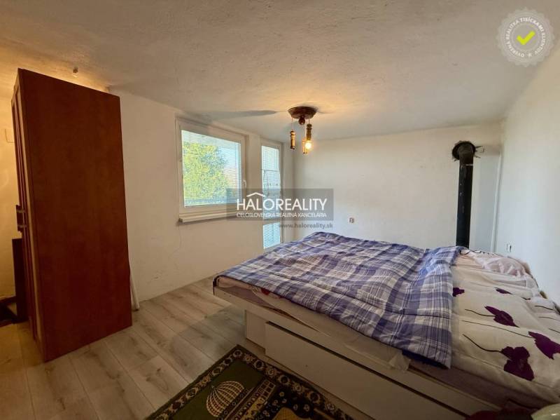 Bedroom with a wardrobe, bed, and floor with a wood decor in the interior of Gardens.