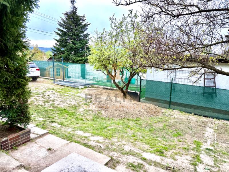 A family house in Bratislava-Záhorská Bystrica, Podkerepušky with a grassy yard and trees.
