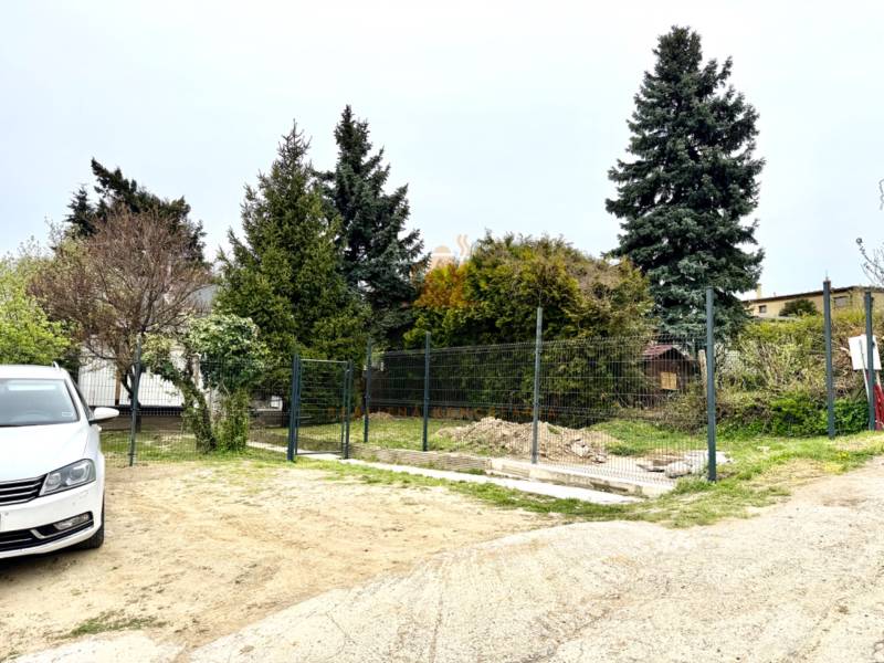 Family house on Podkerepušky Street in Bratislava - Záhorská Bystrica, with a car and trees.