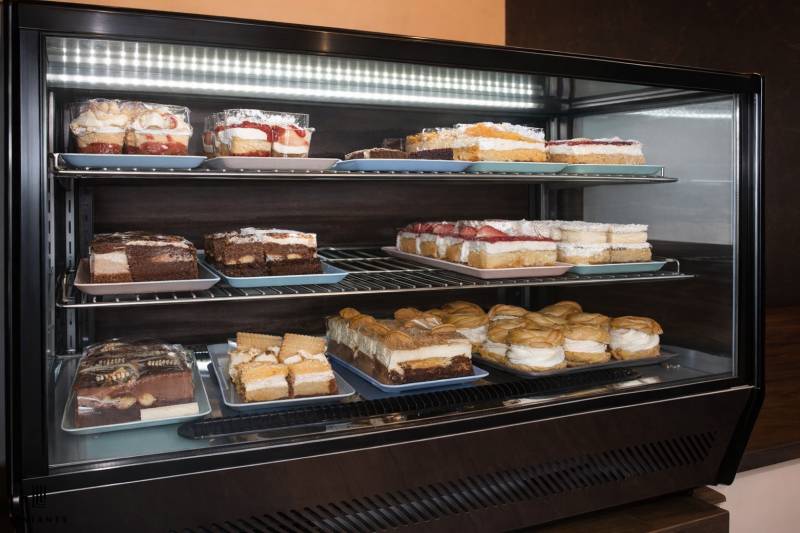 In the gastro area, various types of desserts are displayed in the refrigerator.