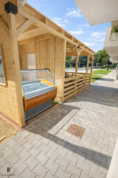 Wooden gastro spaces on Dukelská Street in Bernolákovo with an ice cream display.