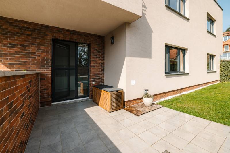 Terrace of a 4-room apartment on Cesta na Klanec in Bratislava - Lamač with a green lawn.