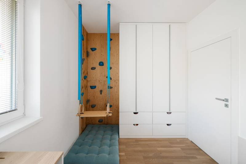 A children's room with a climbing wall and a swing in a 4-room apartment.