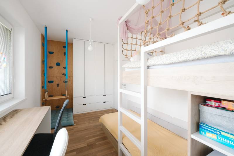 A children's room in a 4-room apartment with a bunk bed and a play wall.