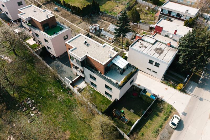 Aerial view of apartment roofs and gardens on Cesta na Klanec in Lamač.