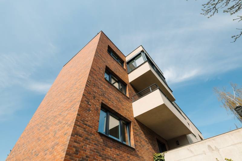 Apartment building on Cesta na Klanec, Bratislava - Lamač, with a brick facade and balconies.