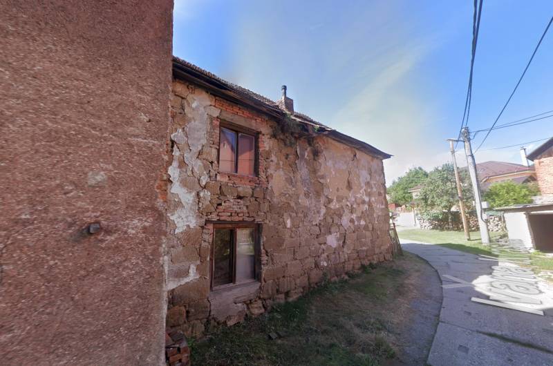 A family house on Ivana Krasko Street in Handlová with damaged facade.