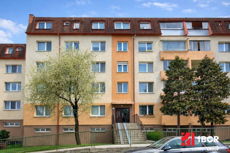 Apartment building on Latorická Street in Bratislava - Dolné hony with parking in the foreground.