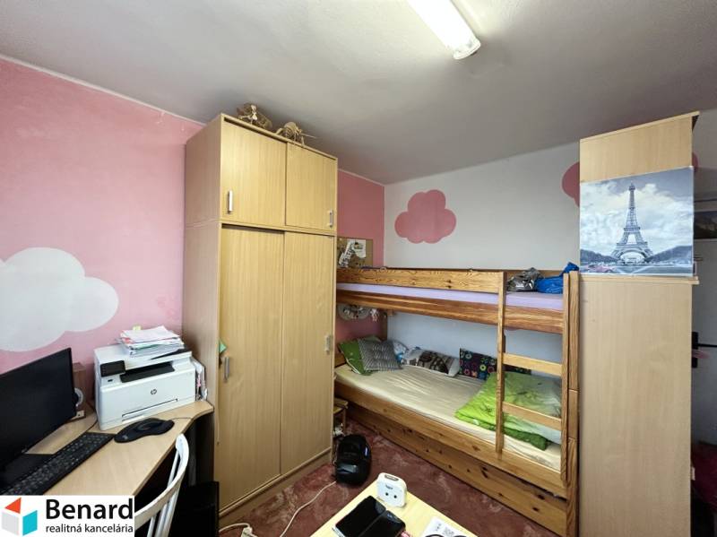 A room in a 3-room apartment with a built-in wardrobe, a bunk bed, and a desk.
