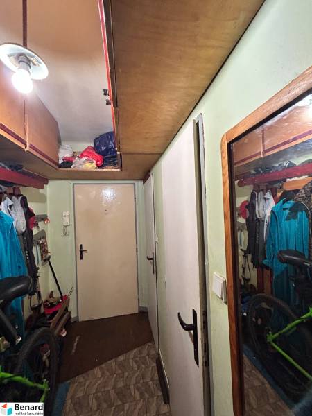 A hallway with storage space and a bicycle in a 3-room apartment.