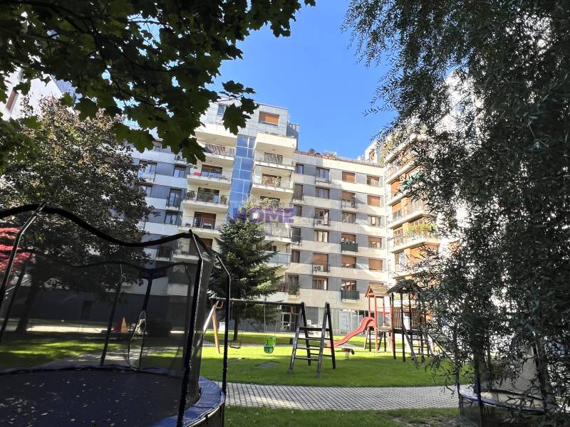 Apartment building on Drieňová Street in Bratislava - Ružinov with greenery and a children's playground.