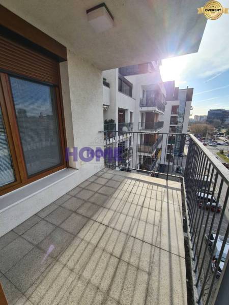 A balcony with tiles and a view of the surroundings in Bratislava - Ružinov on Drieňová Street.