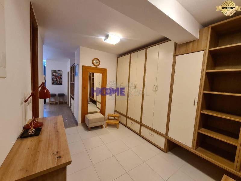 A hallway with storage cabinets and wooden decor in a 2-room apartment.