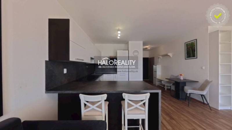 Kitchen and dining area in a 2-room apartment with a wooden decor floor.