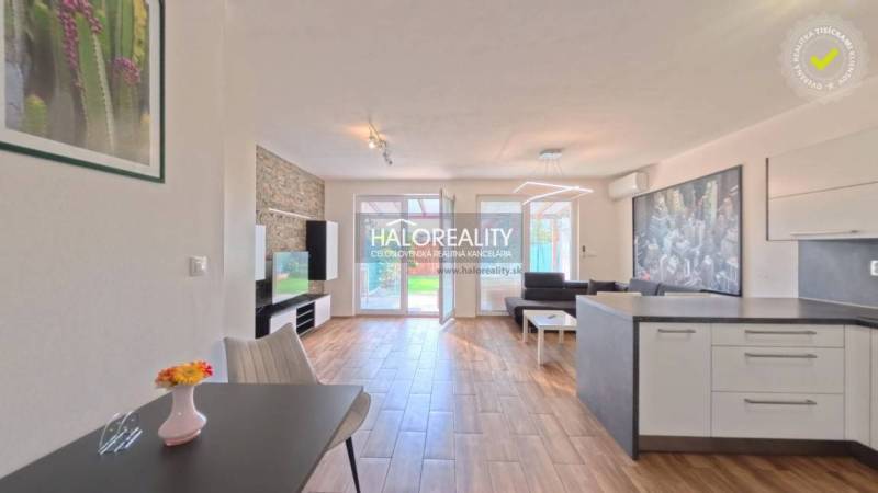 2-room apartment with wood-patterned flooring and a bright kitchen.