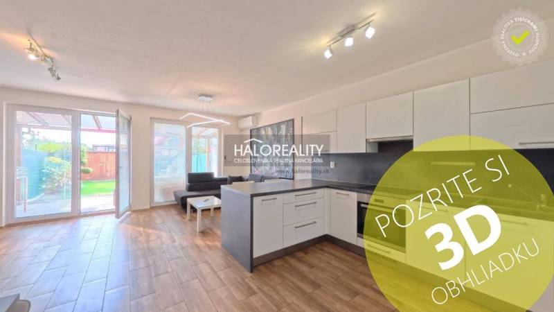 Kitchen and living room in a 2-room apartment with a wooden decor floor, access to the terrace.