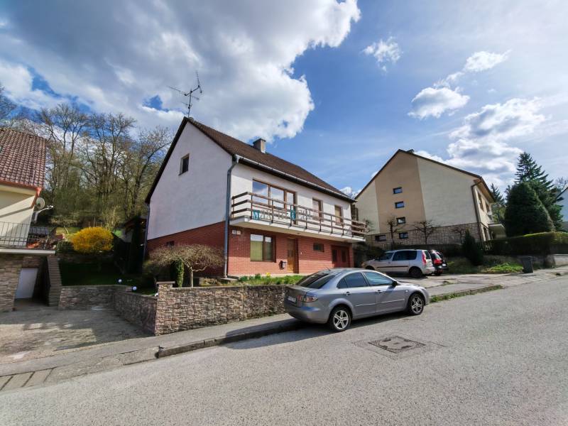 A family house on Závršky Street in Myjava with cars parked in front of it.