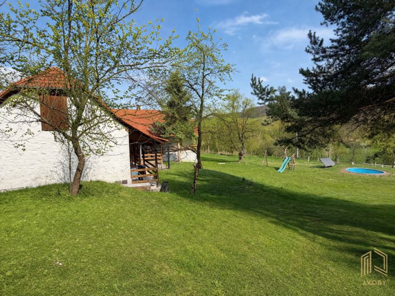 A family house in Podbranč with a spacious garden, swimming pool, and children's playground.
