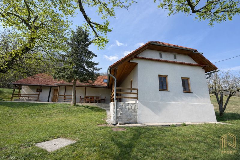 A family house in Podbranč with a garden and terrace, surrounded by nature and trees.