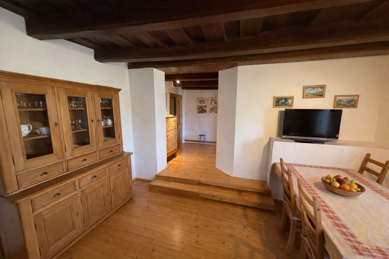 Interior of a family house with wooden furniture and a floor with a wood design.