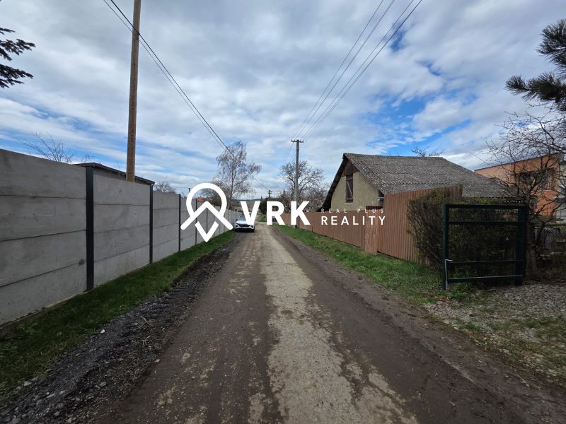 A rural road in Bohdanovce, with residential plots on both sides of the street.