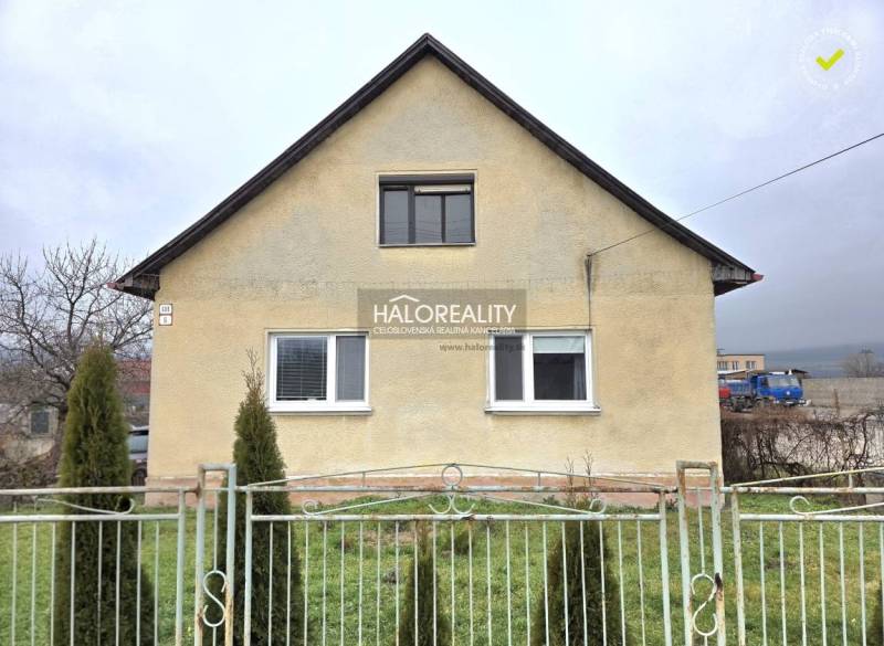 A family house in Čereňany with a simple facade and a front garden behind a fence.