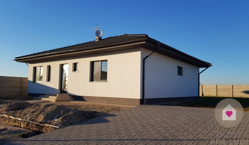 A family house on Jelšová Street in Bernolákovo with a white-gray facade and a yard.