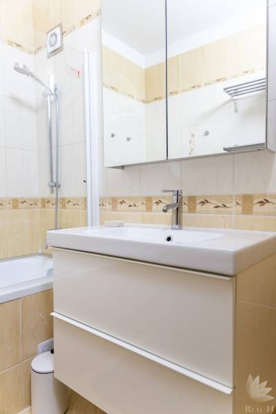 Bathroom with a shower, mirror cabinet, and sink in a 4-room apartment.