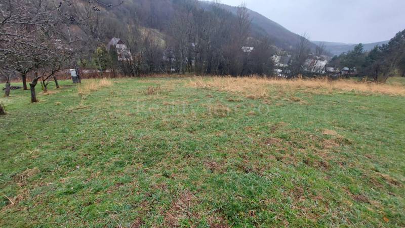 Grassy recreational plots in Púchov with views of the surrounding nature and village houses.