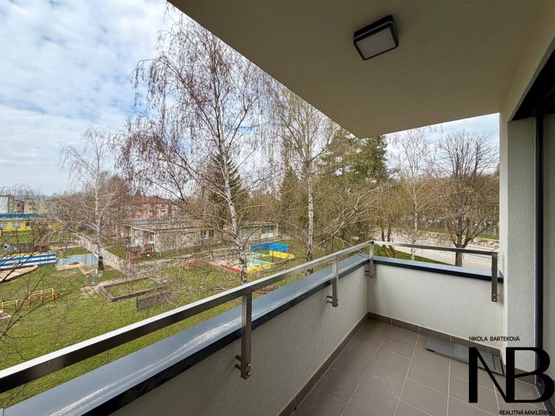 A balcony with a view of greenery in a 1-room apartment on Soblahovská in Trenčín.