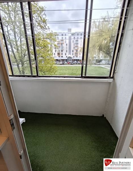 A glazed loggia with greenery in a 4-room apartment overlooking Wolkrova Street in Petržalka.