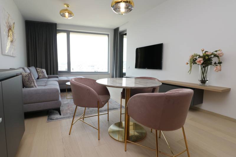 Living room in a two-room apartment with a wooden decor floor and stylish furniture.