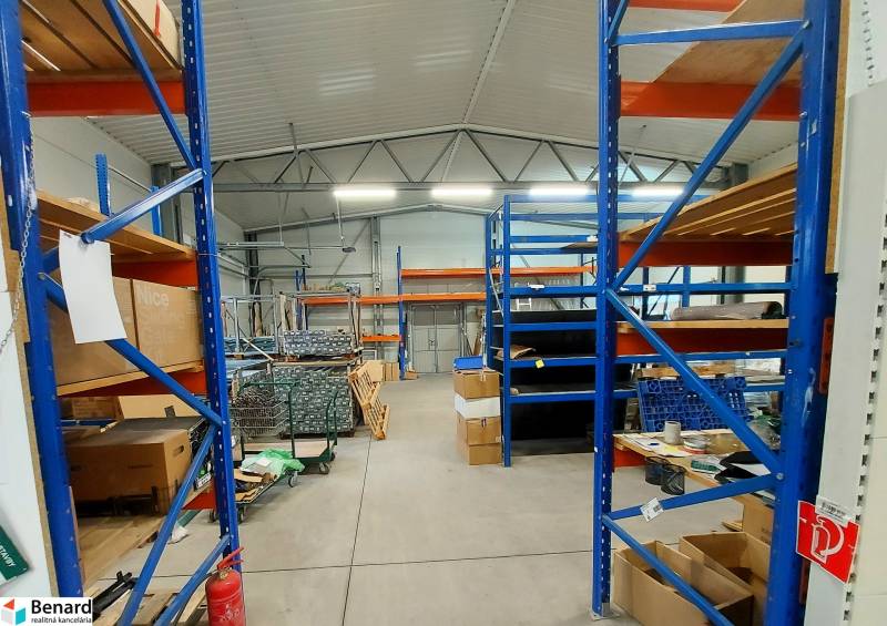 Commercial spaces with high shelves, cardboard boxes, and industrial ceiling.