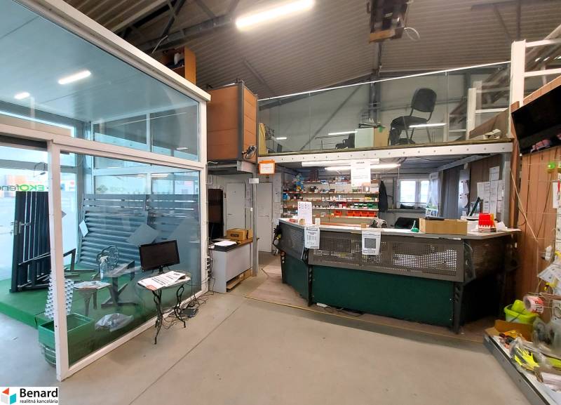 Commercial spaces with a glass wall and a workspace, floor with wood decor.