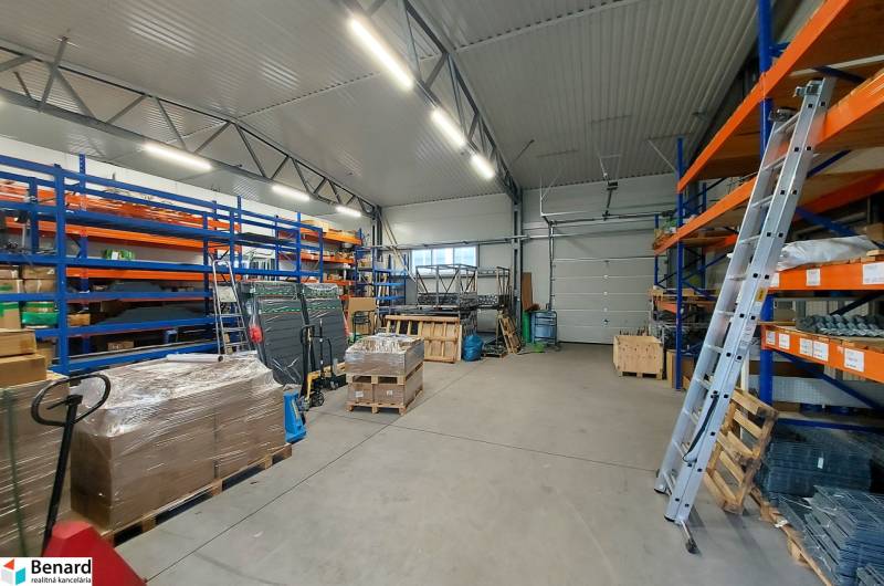 Warehouse spaces with shelves, pallets, and tools in commercial premises.