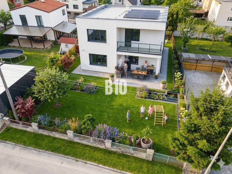 A family house in Martin with a landscaped garden, a gazebo, and solar panels on the roof.