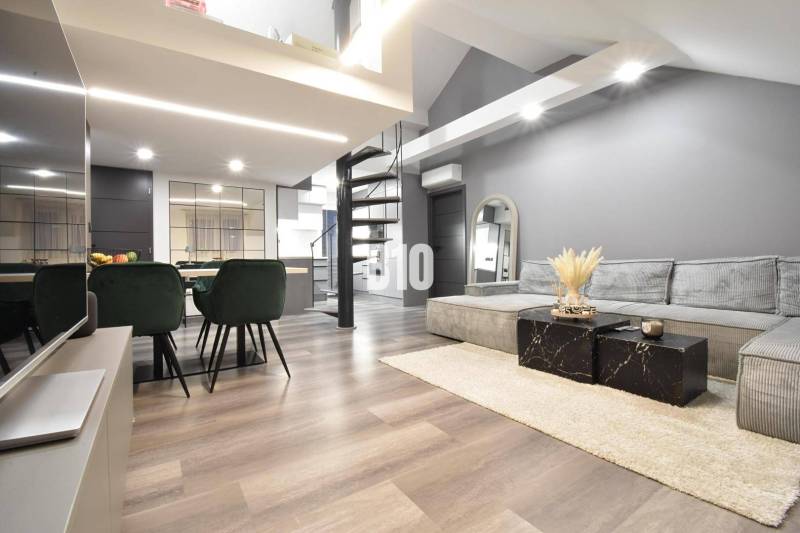 Elegant living space in a 4-room apartment with wood-patterned flooring and a spiral staircase.