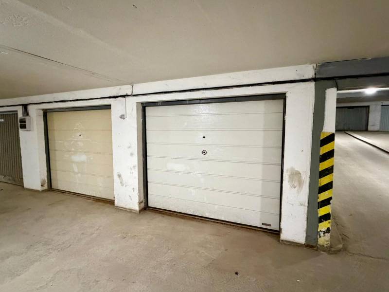 Garages with white doors on Nová Ves street in the town of Dunajská Streda.