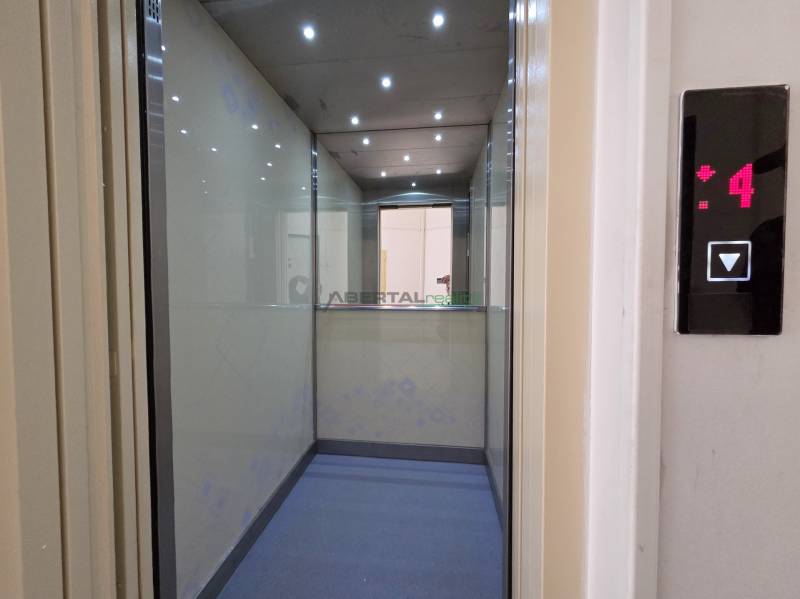 The interior of the elevator with lights and a mirror shows the 4th floor in a 3-room apartment.